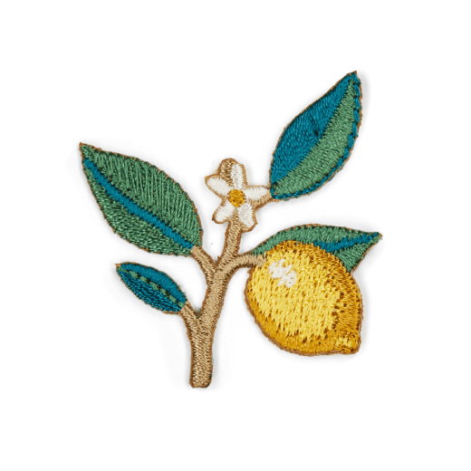 An embroidery patch in the shape of a branch featuring four green leaves and and a lemon.